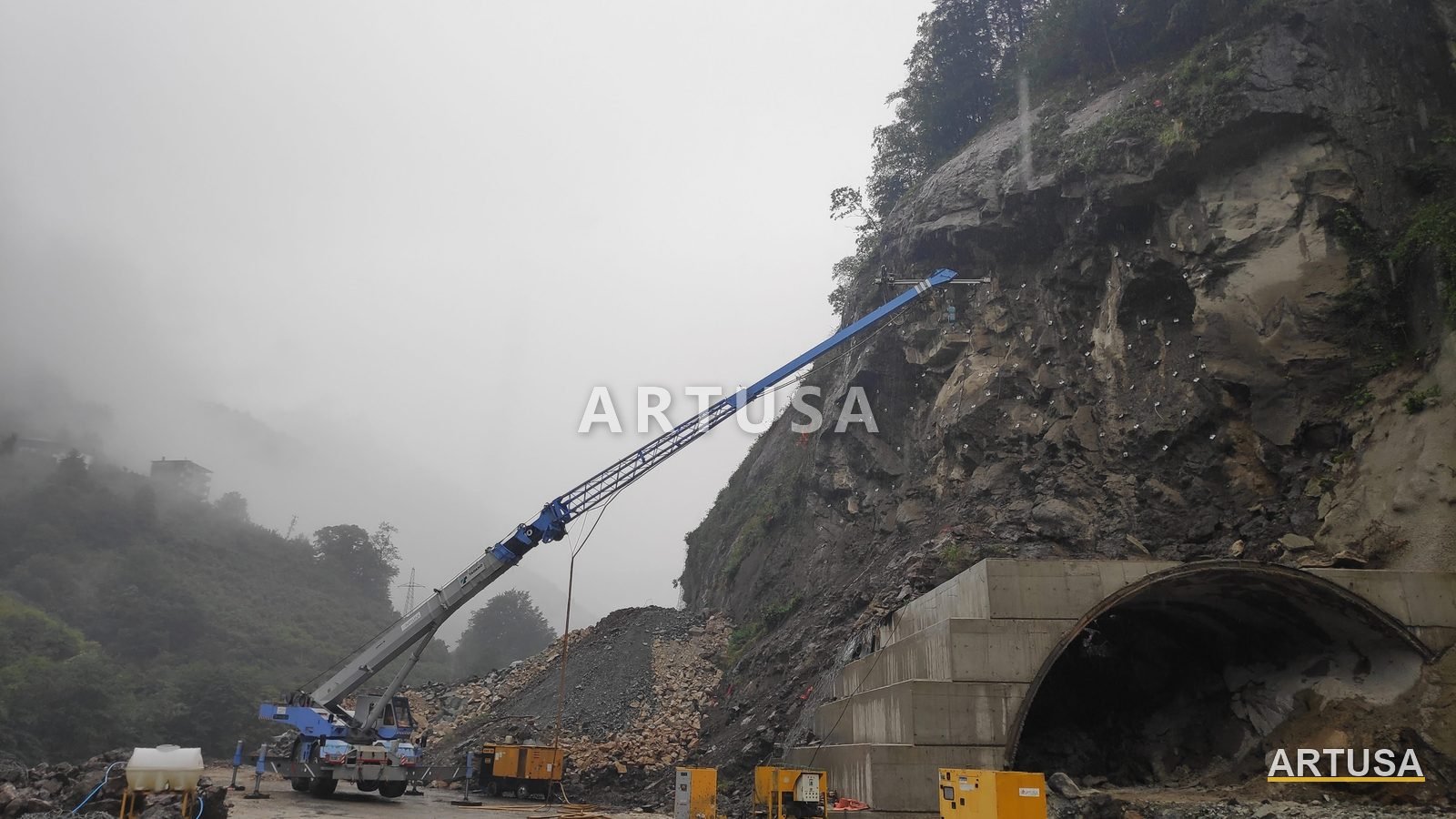 Crew in a basket crane above a tunnel portal