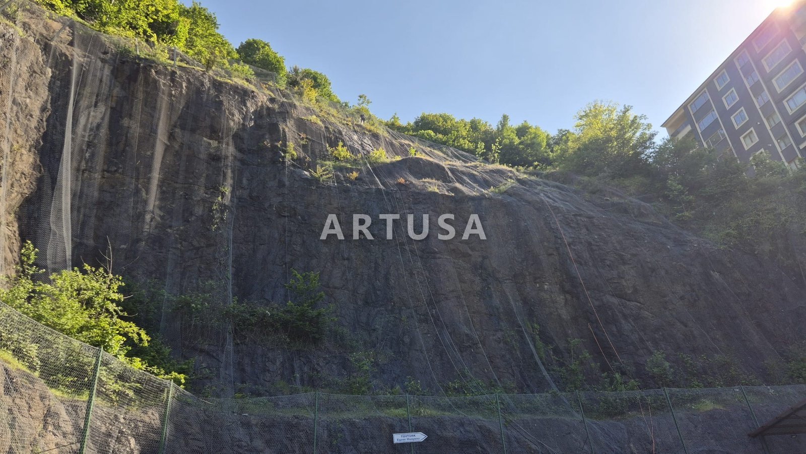 Mesh drapery on a high rock cut